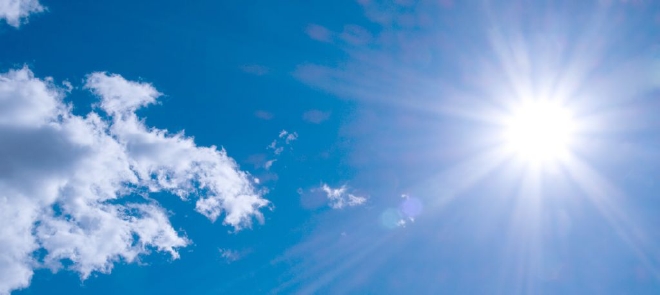 Anti-reflective coating a blue sky with clouds and the sun